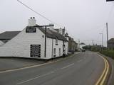 NZ tourist outside the last pub in England on an overcast day