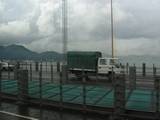 Smoggy view of boats at anchor in Hong Kong from the airport bus on the way into Kowloon