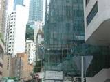 Bamboo scaffolding covered with green mesh to stop rubbish blowing around (not for catching builders)