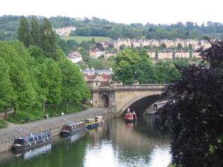 Terraced houses in Bath with canal longboats